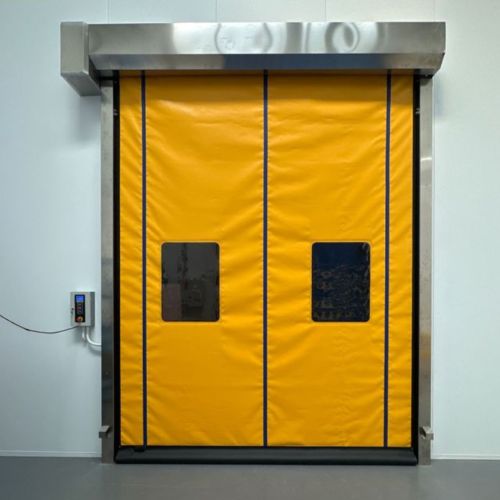 Yellow high-speed industrial roller door with vision windows in clean facility